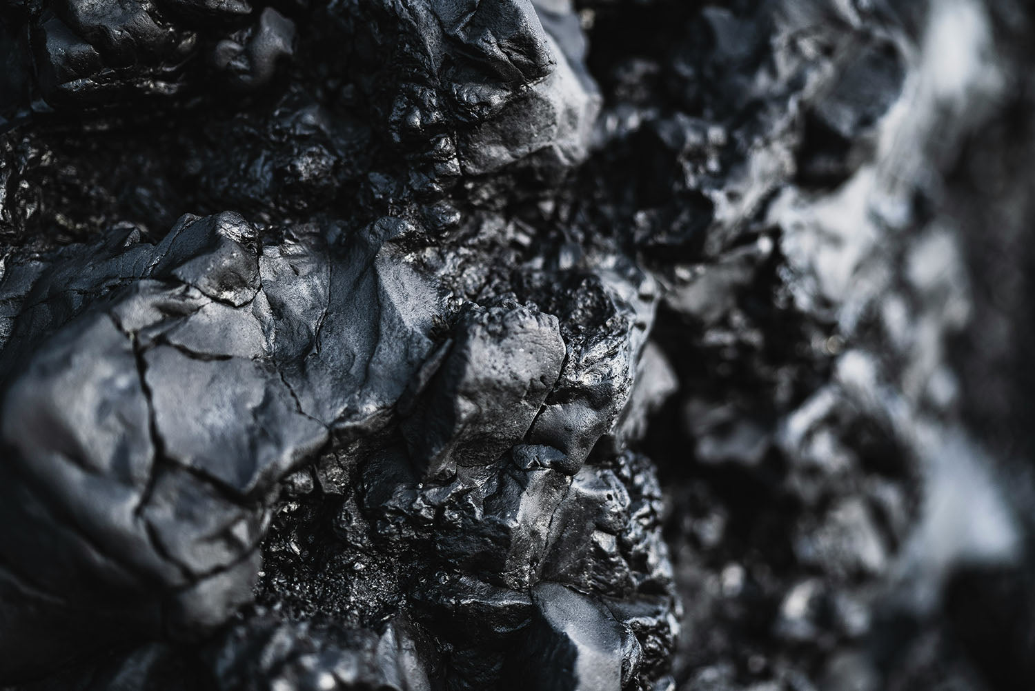 Raw black obsidian mineral with deep dark shine, protective crystal for grounding energy