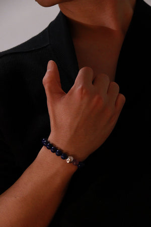 Waxing Gibbous crystal bracelet worn on wrist, deep blue and purple gemstones